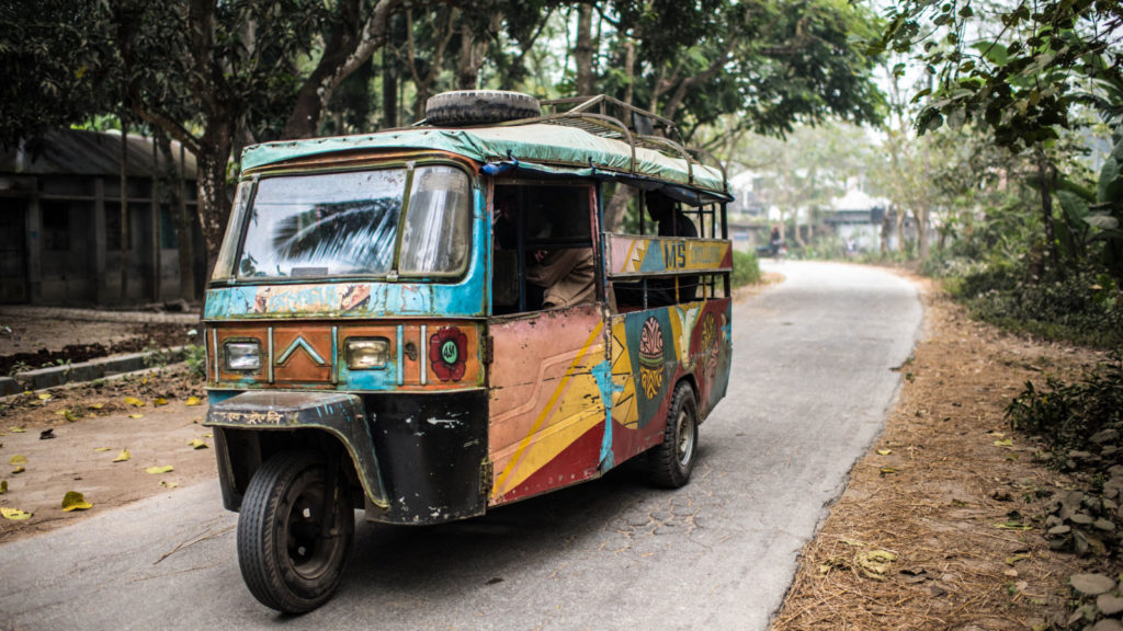 A brightly painted tuk tuk travels through the village of Harinakunda, Bangladesh.