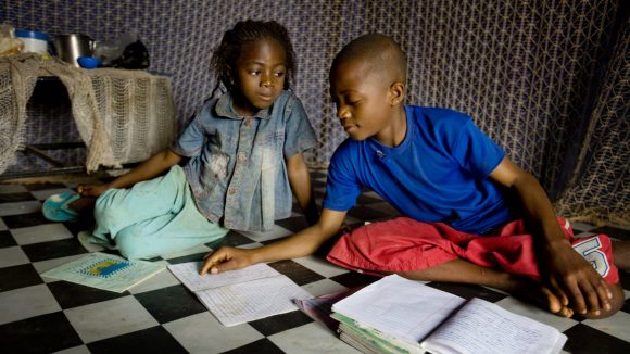 Jacob studies with his little sister Helen.