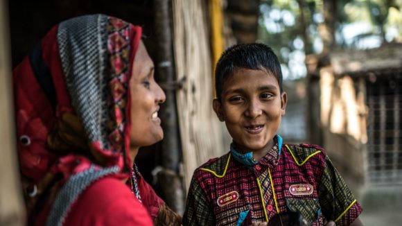 Polok laughs with his mother.