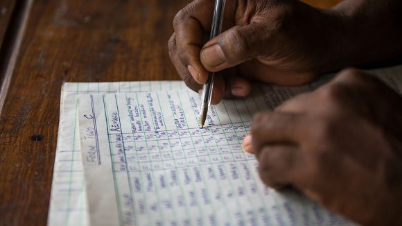 An eye health worker fills in some paperwork.