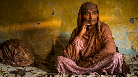 Zamurrad sits alone in her home in Pakistan.